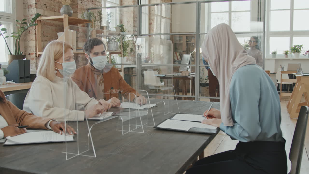 Muslim Woman Singing Document at Job Interview