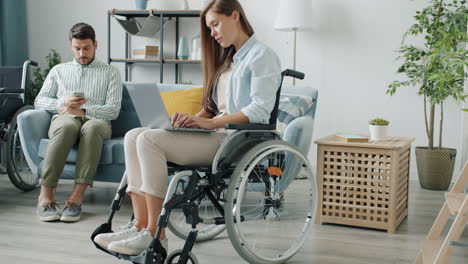 couple in wheelchairs at home