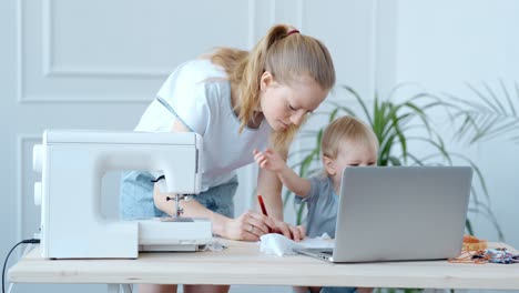 mom and toddler sewing project at home