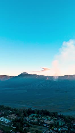 vertical, aerial: drone hyperlapse of tengger caldera with active mount bromo volcano at sunset in east java, indonesia