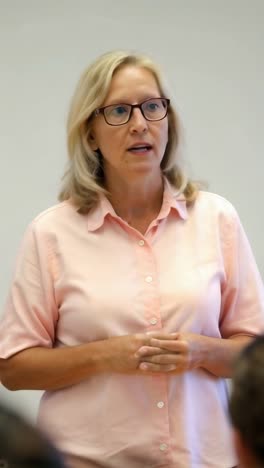 an adult businesswoman giving a presentation in the office.