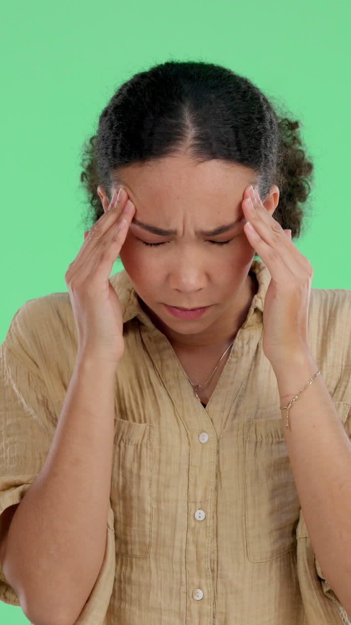 Young Woman Experiencing a Painful Headache on Green Screen