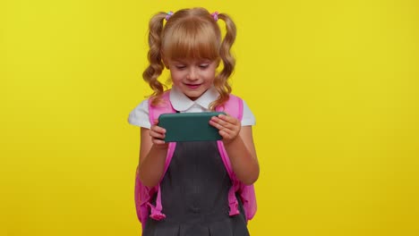 Worried-funny-school-girl-wear-backpack-enthusiastically-playing-racing-video-games-on-mobile-phone