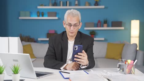 home office worker man talking on the phone facetime happily.