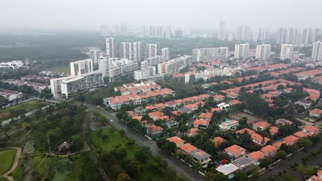 drone dolly above ho chi minh city distrct 7 skyline and homes, foggy day