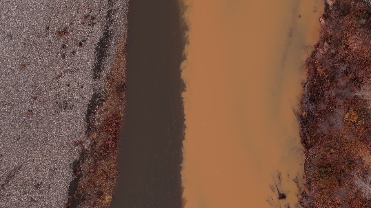 Ogilvie River With Muddy Water Flowing In Yukon Territory, Canada. aerial topdown shot