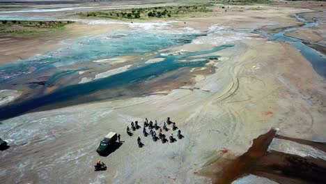 aerial view of motorcycle riders touring around lake magadi, kenya