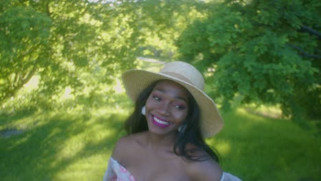 black woman on picnic in park looking up eye contact smiling