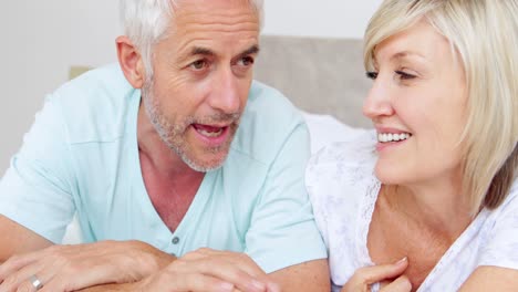 Happy-couple-chatting-on-bed