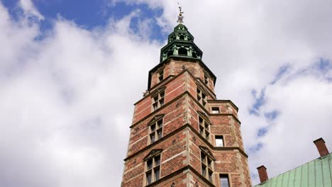 Several-birds-flying-around-Rosenborg-Castle-tower,-Copenhagen