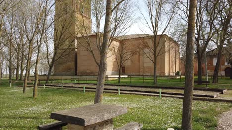 black campervan parked by a church in the springtime