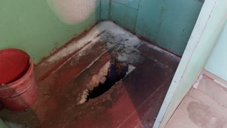 outdoor wooden squat toilet during an icy winter in poor mongolia