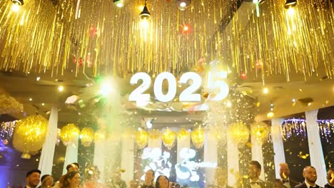 people celebrating new year's eve with confetti and a 2025 sign