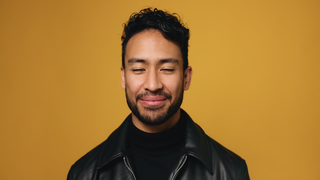 Portrait of a smiling man in a black leather jacket
