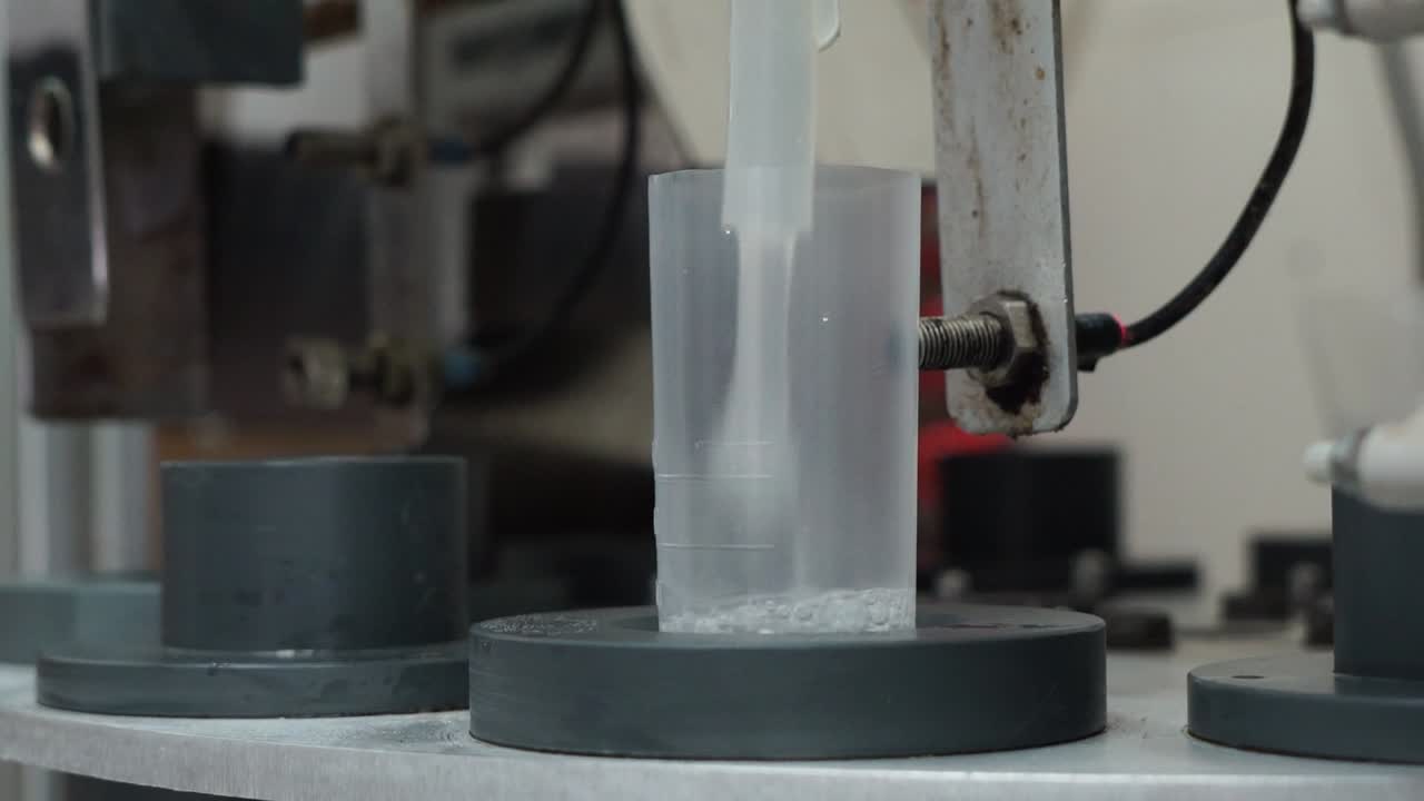 Machine in insemination center collecting semen in flasks