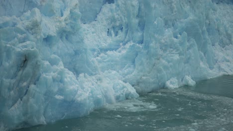 Melting-Ice-From-Glacier-Falling-Into-Water,-Close-Up