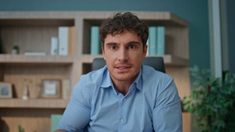 anxious manager talking web conference closeup. emotional man discussing problem