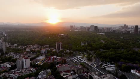 Aerial-view-approaching-the-Chapultepec-park,-colorful-evening-in-Mexico-city