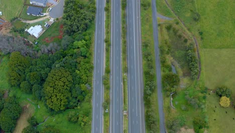 local and express lane of carriageways along green meadow in byron bay to brisbane, queensland, australia