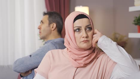 A-sad-Muslim-woman-wearing-a-headscarf-is-offended-by-her-husband-and-does-not-speak.