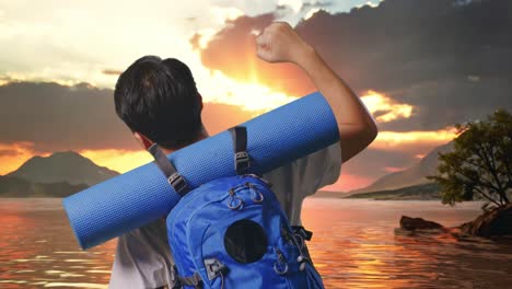 close up back view of a male hiker with mountaineering backpack screaming goal celebrating the success at a lake