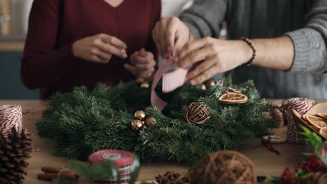 couple making natural christmas decorations