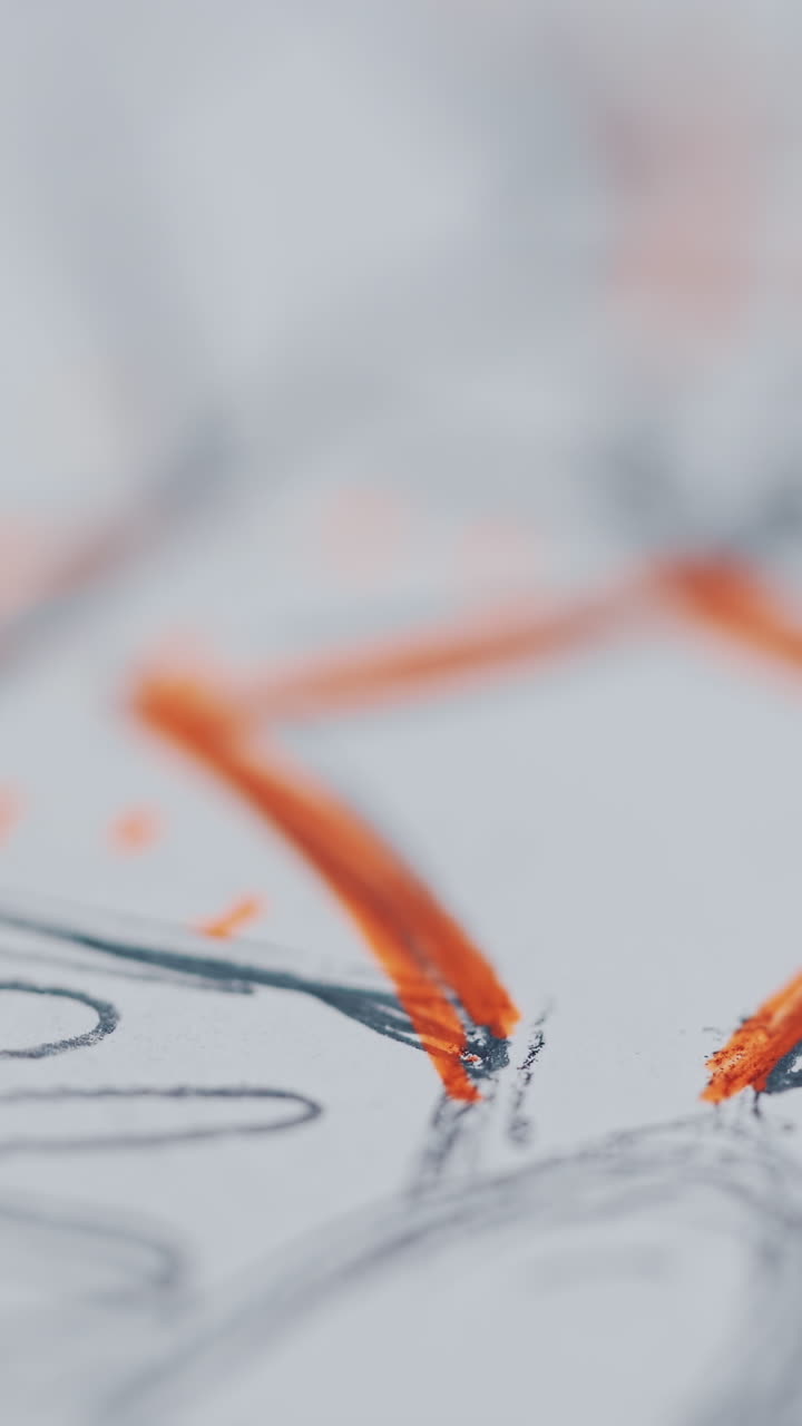 Sketch of woman's clothes written by pencils on paper. Orange and gray illustration of fashionable design of a dress. Designer's outline for sewing clothes. Close-up Vertical video