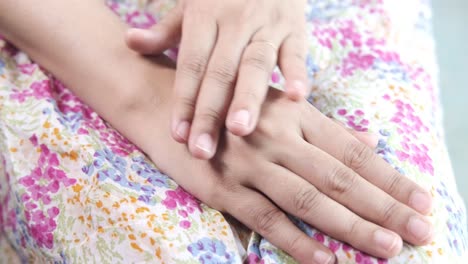 woman applying lotion to her arm