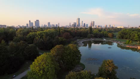 skyscrapers of warsaw and water pond in park, aerial view