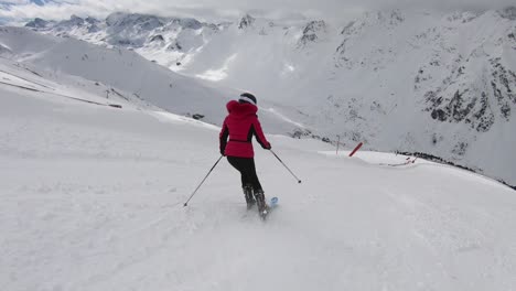 woman is skiing down the slopes with great ski technique and in perfect rythm