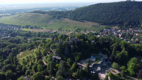 ruins of burg baden or badenweiler castle fortification atop lush hill, drone