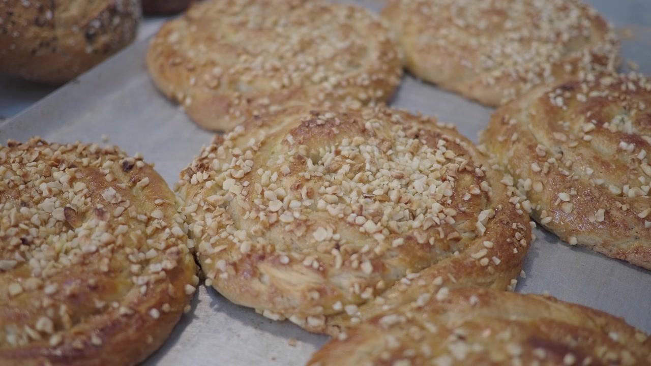 Freshly Baked Nut-Topped Pastries on a Baking Tray