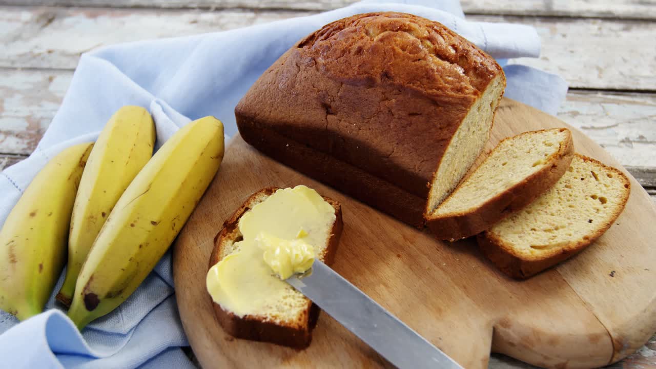 Butter spread on bread slice and bananas