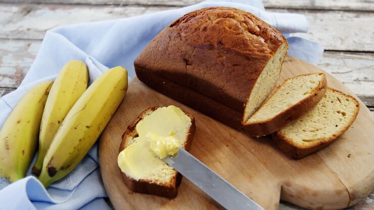 Butter spread on bread slice and bananas