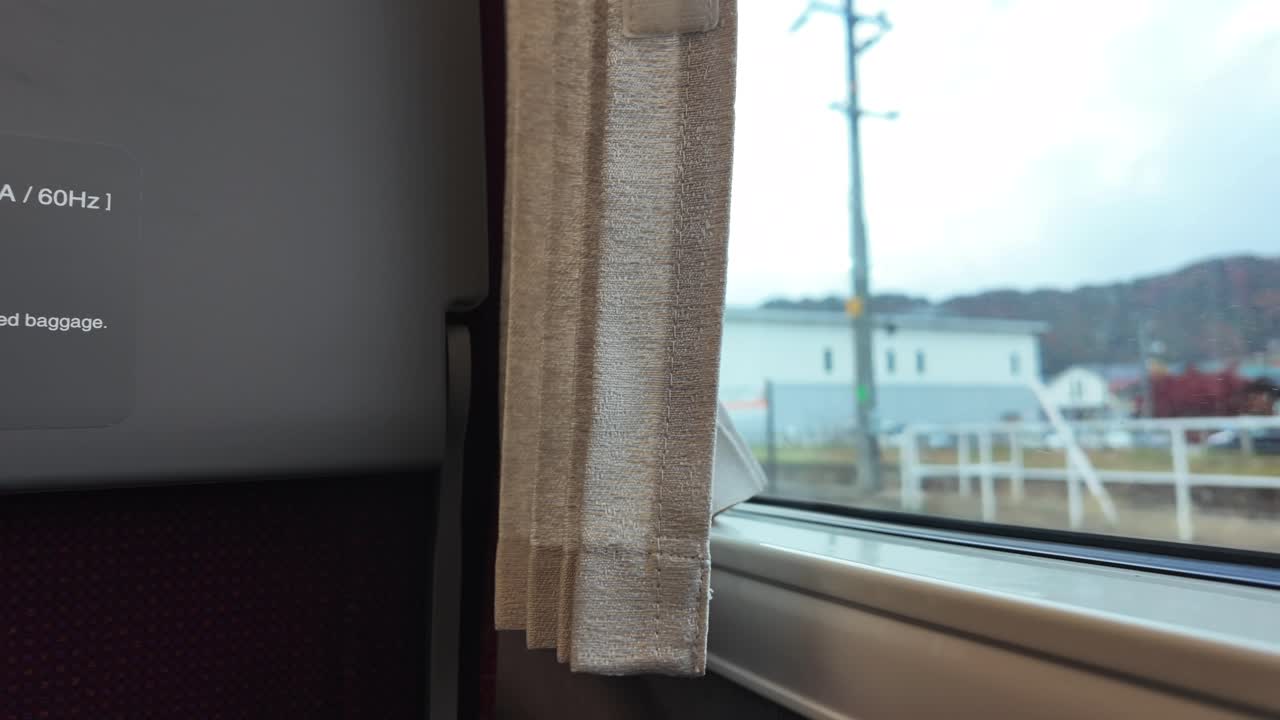 Cozy Train Window View With Curtain Drape and Scenic Landscape Outside