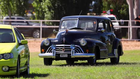 classic car driving by during a sunny day event