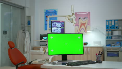 computer with green screen in stomatological clinic