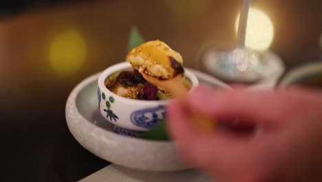 hands serving and garnishing a steamed egg