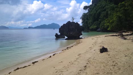 Deserted-Tropical-Beach,-Lush-and-Limestone-Rock-on-Rainy-Day