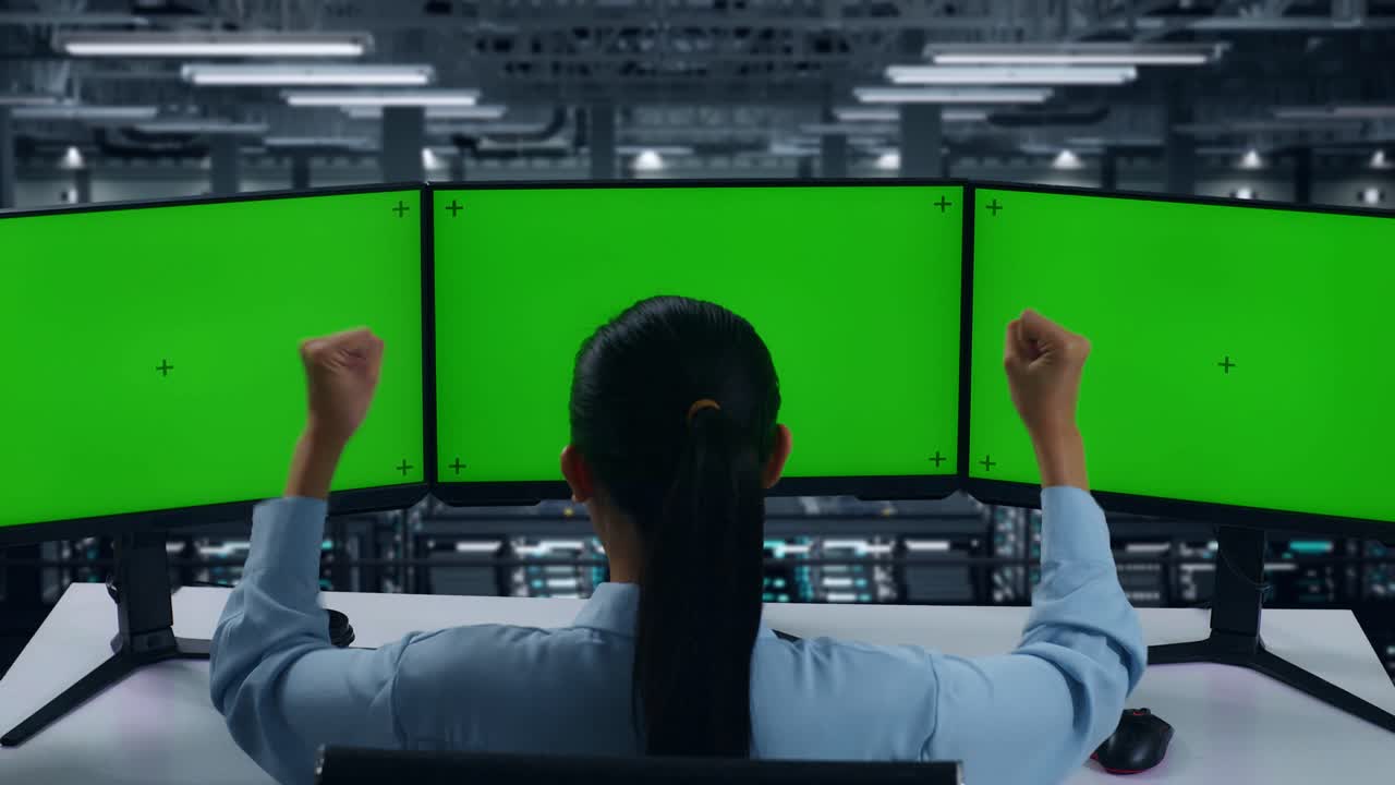 Back View Of Happy Asian Woman Celebrating While Working With Mock Up Multiple Computer Monitor In Data Center