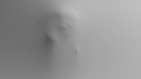a creepy silhouette of a woman appears from the white surface