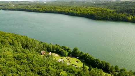 brodno wielkie lake in summer season with green forests on banks - arial turn around view