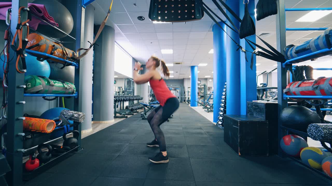 Athletic woman exercising at gym. Young female during fitness training session