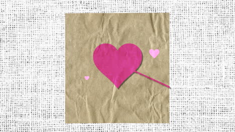 corazones rojos con flecha en papel con textil