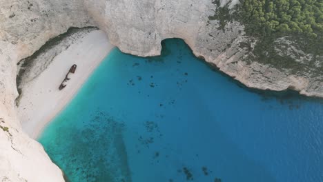 clear turquoise water, a shipwreck on a secluded beach in zante, greece.