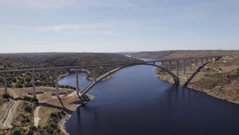 Aerial-view-orbiting-viaduct-bridge-of-the-AVE-high-speed-train-over-the-Almonte-river-in-Caceres