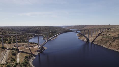 aerial view orbiting viaduct bridge of the ave high speed train over the almonte river in caceres