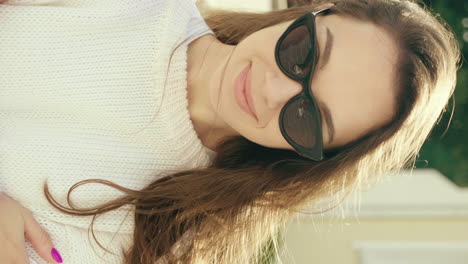 woman in sunglasses and a sweater