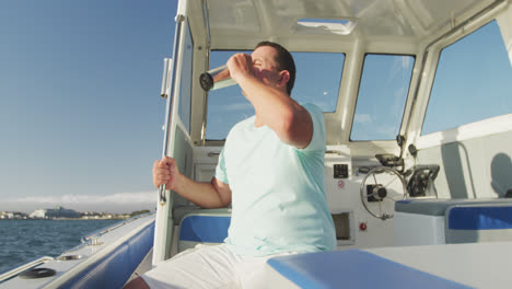 side view of a caucasian man on a boat drinking