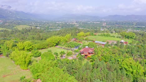 Aerial-circling-over-modern-elegant-houses-surrounded-by-vegetation-at-Jarabacoa,-Dominican-Republic